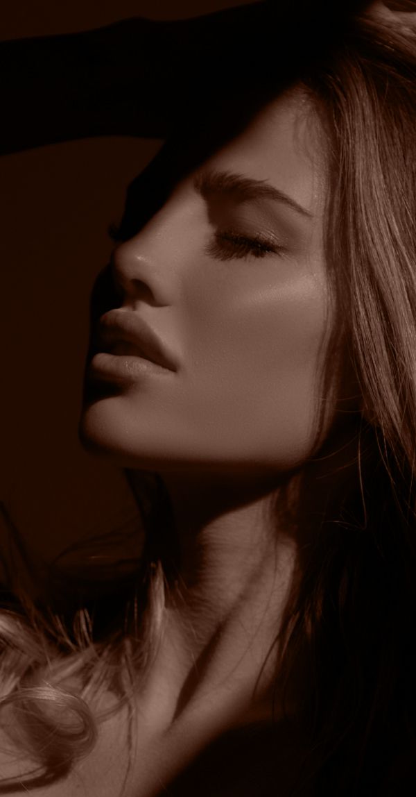 Profile of a woman in soft lighting.