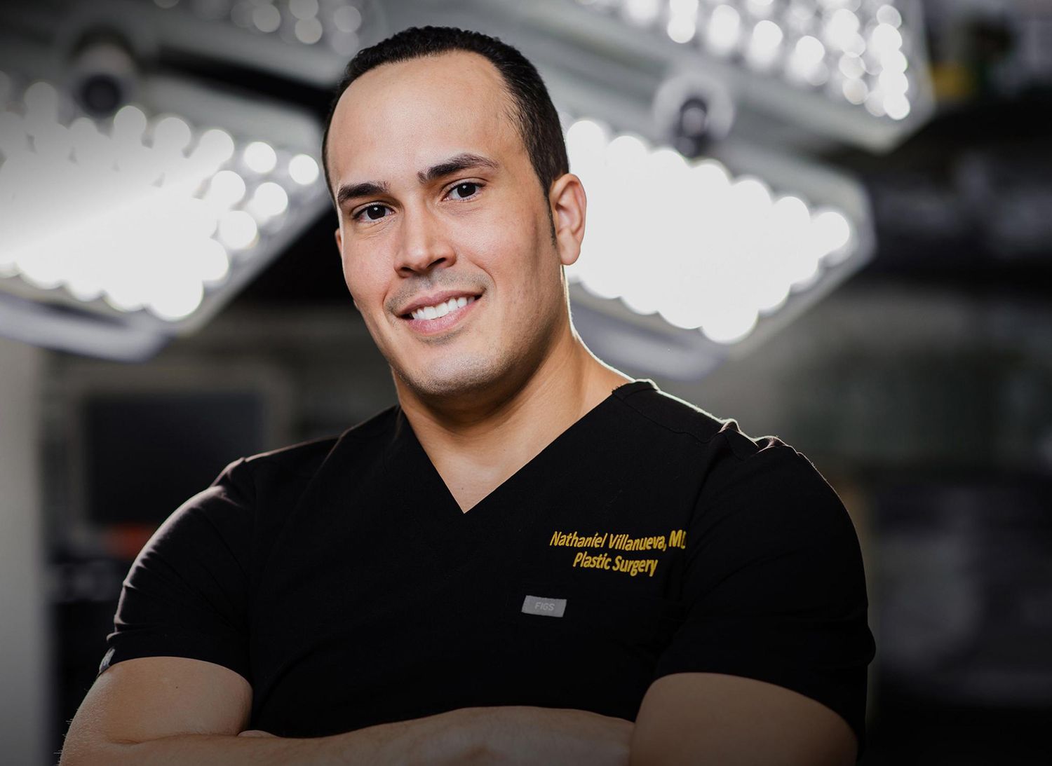 Smiling plastic surgeon in surgical scrubs.