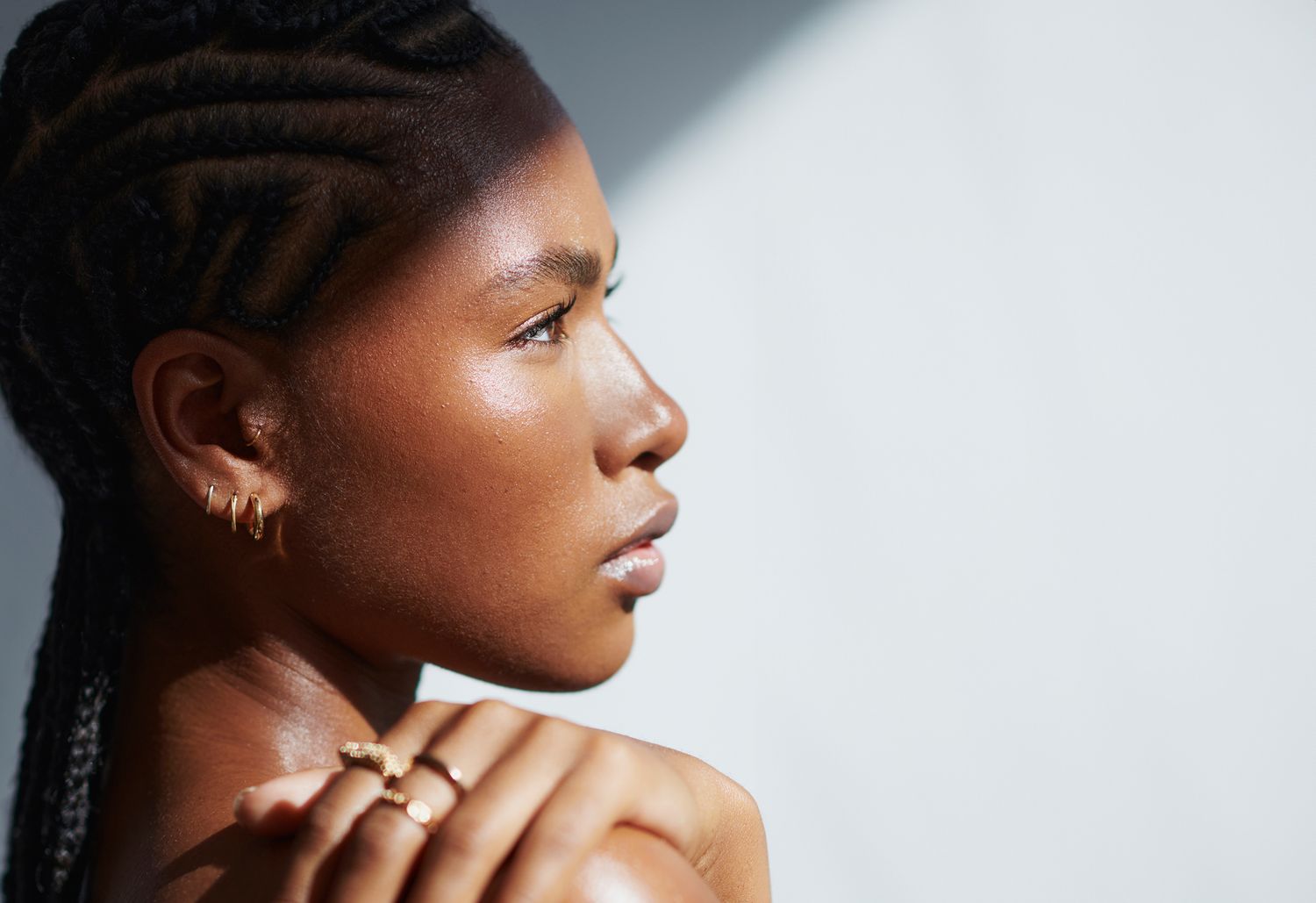 Woman applying cream to her face.