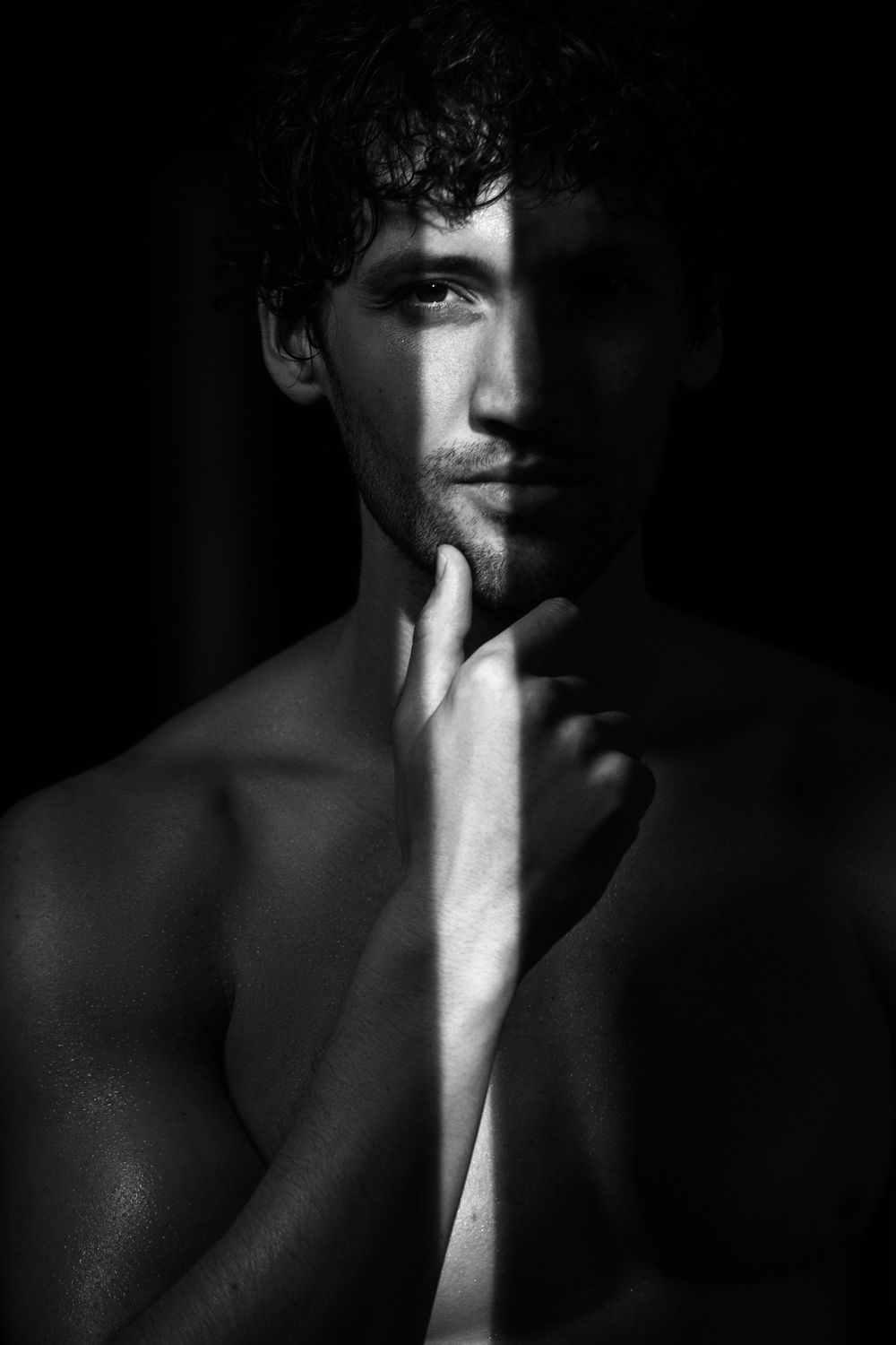 Woman with hands near face, intense expression.