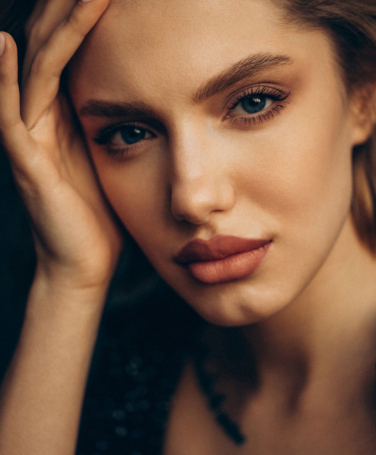 Close-up portrait of a woman with striking features.