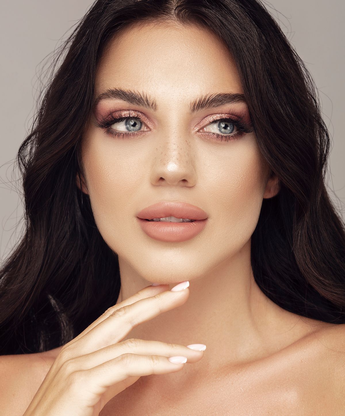 Woman with beautiful makeup and long dark hair.
