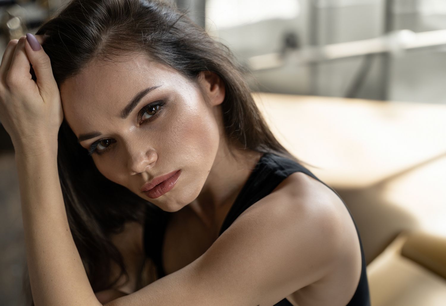 Woman with short hair, gazing over her shoulder.