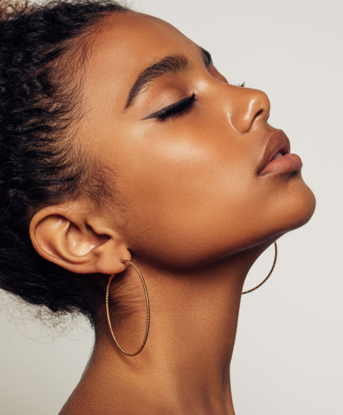 Profile of a woman with hoop earrings.