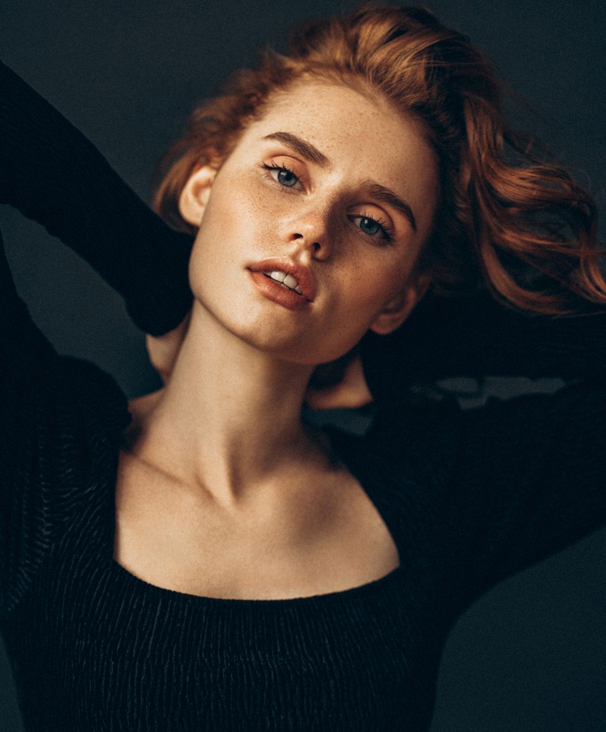 Portrait of a person with red hair and freckles.