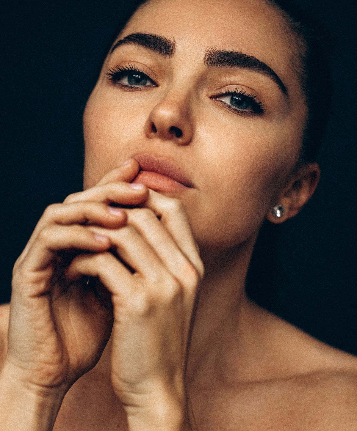 Close-up portrait of woman with thoughtful expression.