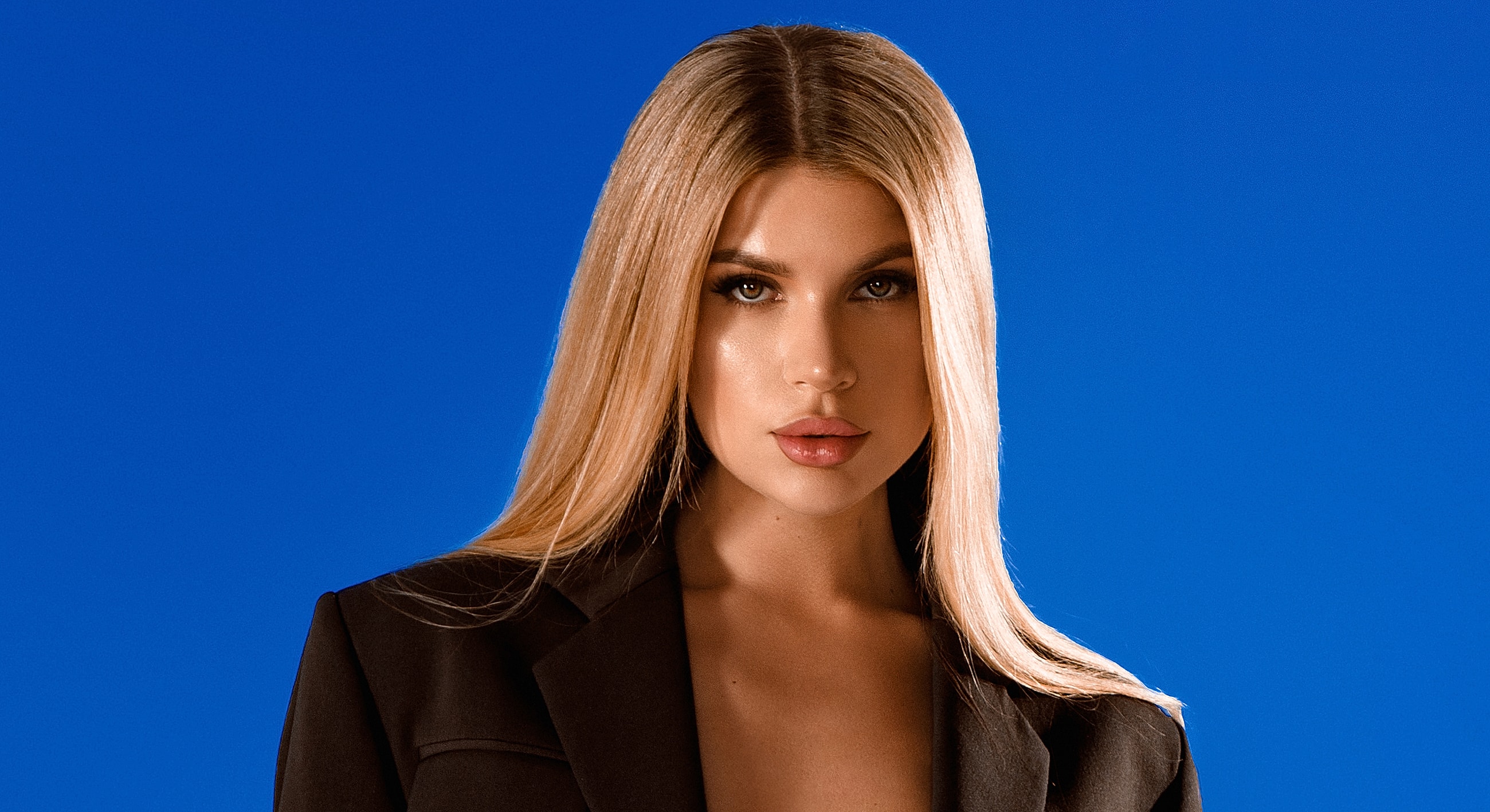 Close-up of a pensive woman with hands.