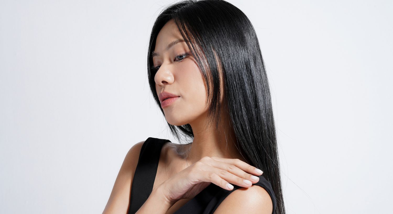 Close-up of a thoughtful woman with hands.